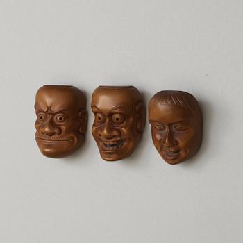 A set of three Japanese Noo mask netsukes, early 20th Century. Signed.