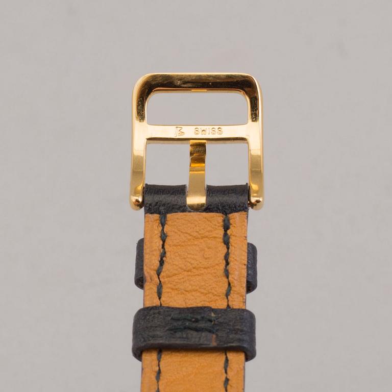 A watch "Kelly Lock" by Hermès.