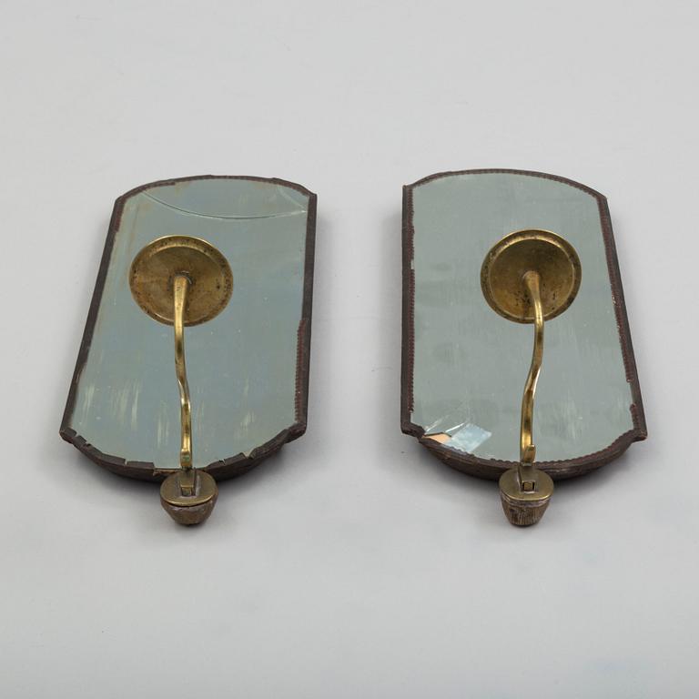 A pair of mirrors with candle sconces, partly 18th century.