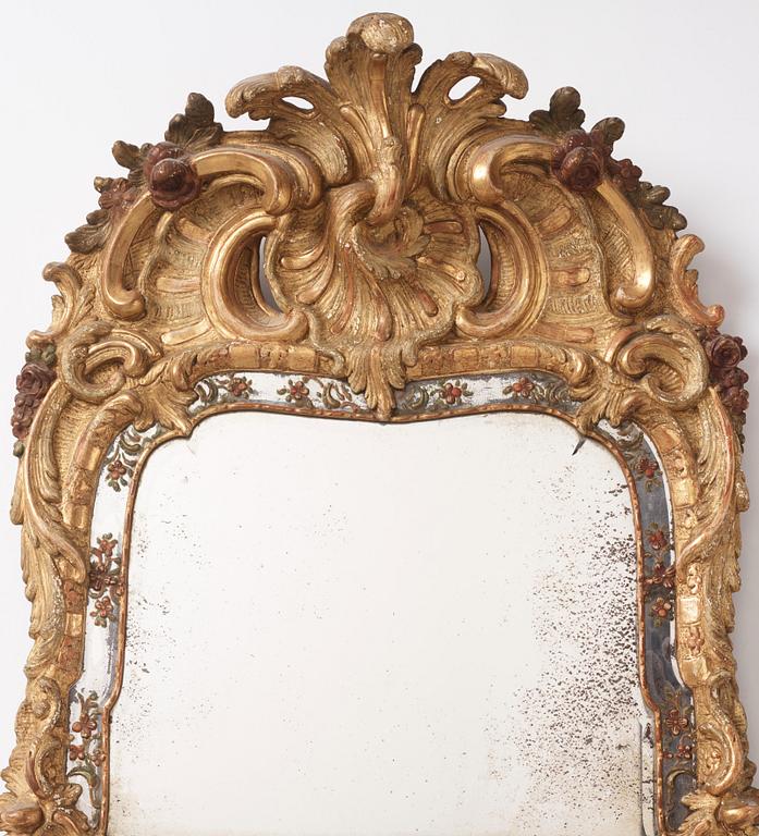 A Swedish giltwood and polychrome-painted Rococo mirror, later part of the 18th century.