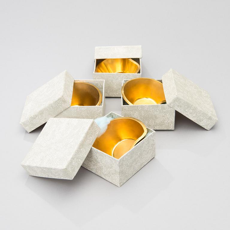 A set of four brass ashtrays, designed in 1947.