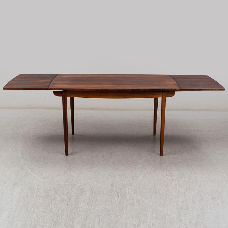 A 1950's/60's rosewood dinner table with four chairs, Denmark.
