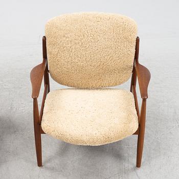 A pair of model FD 136 easy chairs with new sheepskin upholstery by Finn Juhl for France & Son, designed 1958.