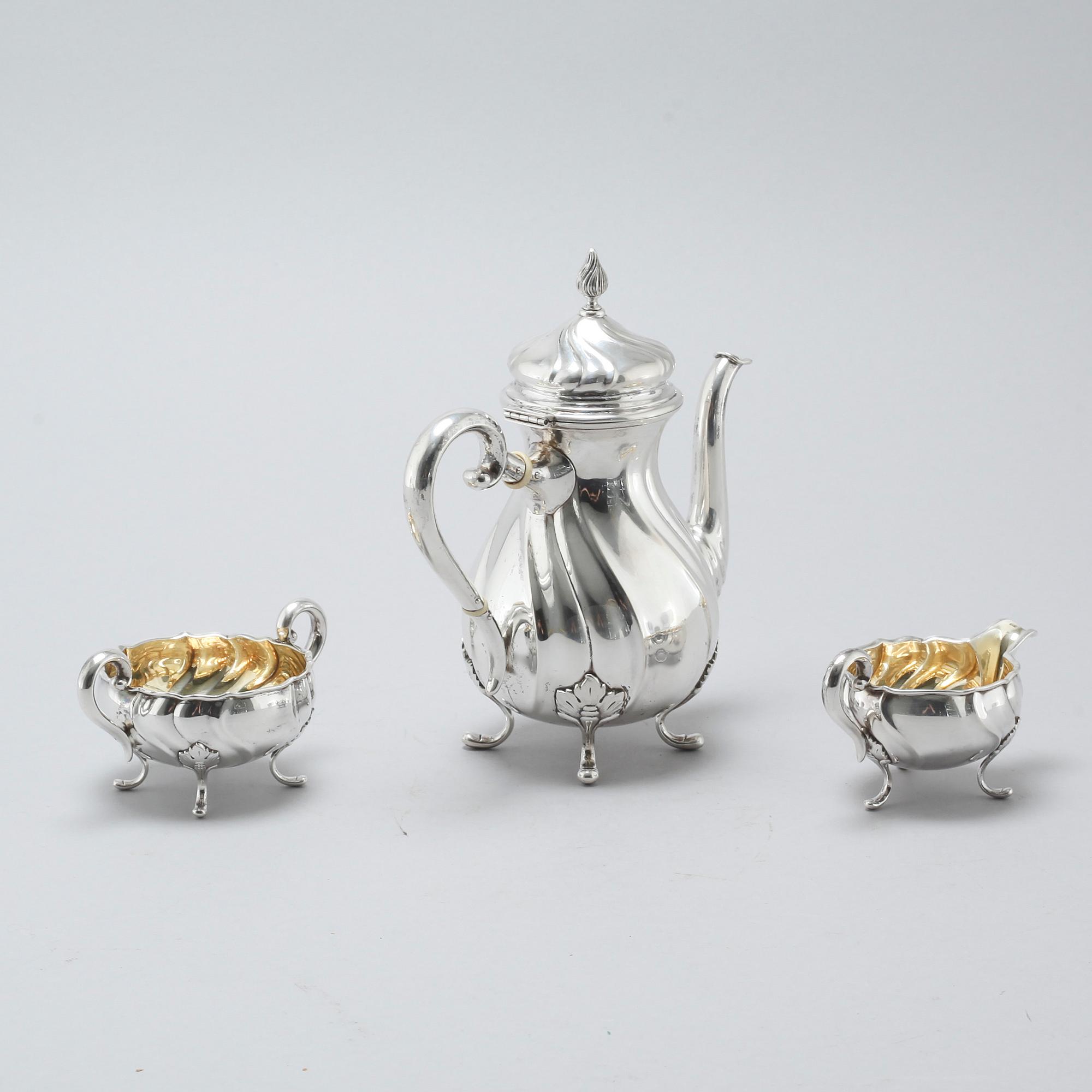 A three piece silver rococo style mocca service by Carl M