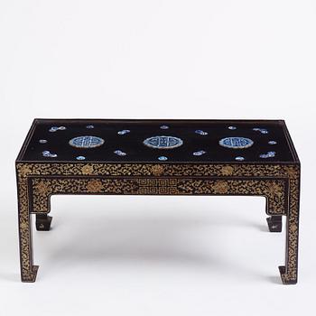 A Chinese black lacquered table with porcelain placques, presumably first half of the 20th century.