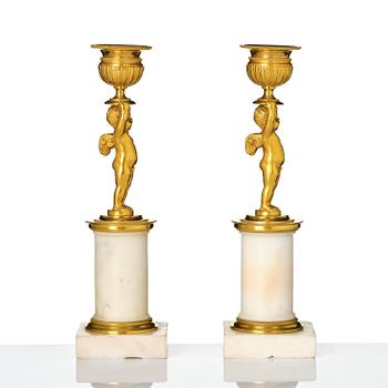 A pair of late Gustavian white marble and ormula candlesticks.