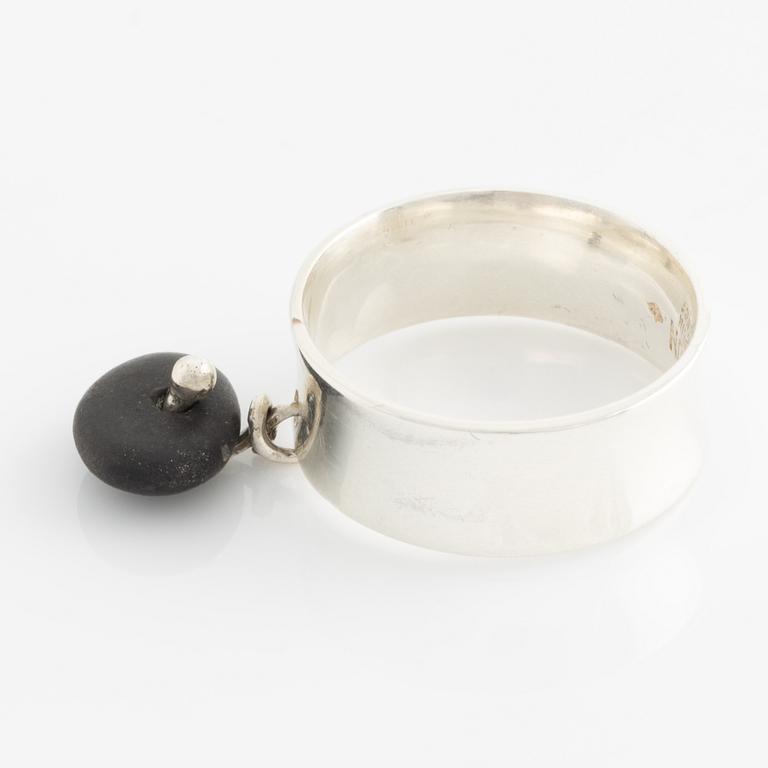 a silver ring with a beach stone pendant.