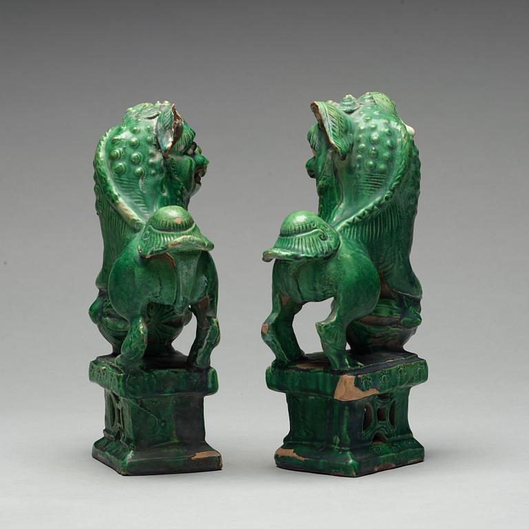 A pair of green glazed buddhist lions, Ming dynasty (1368-1644).