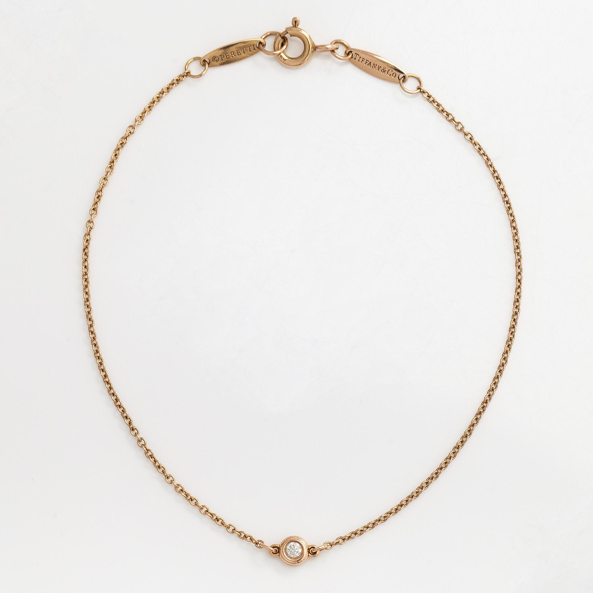 Tiffany & Co, an 18K gold 'Diamonds by the Yard' bracelet with a brilliant-cut diamond.