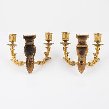 A pair of Empire-style ormolu two-light wall lights, 19th Century.