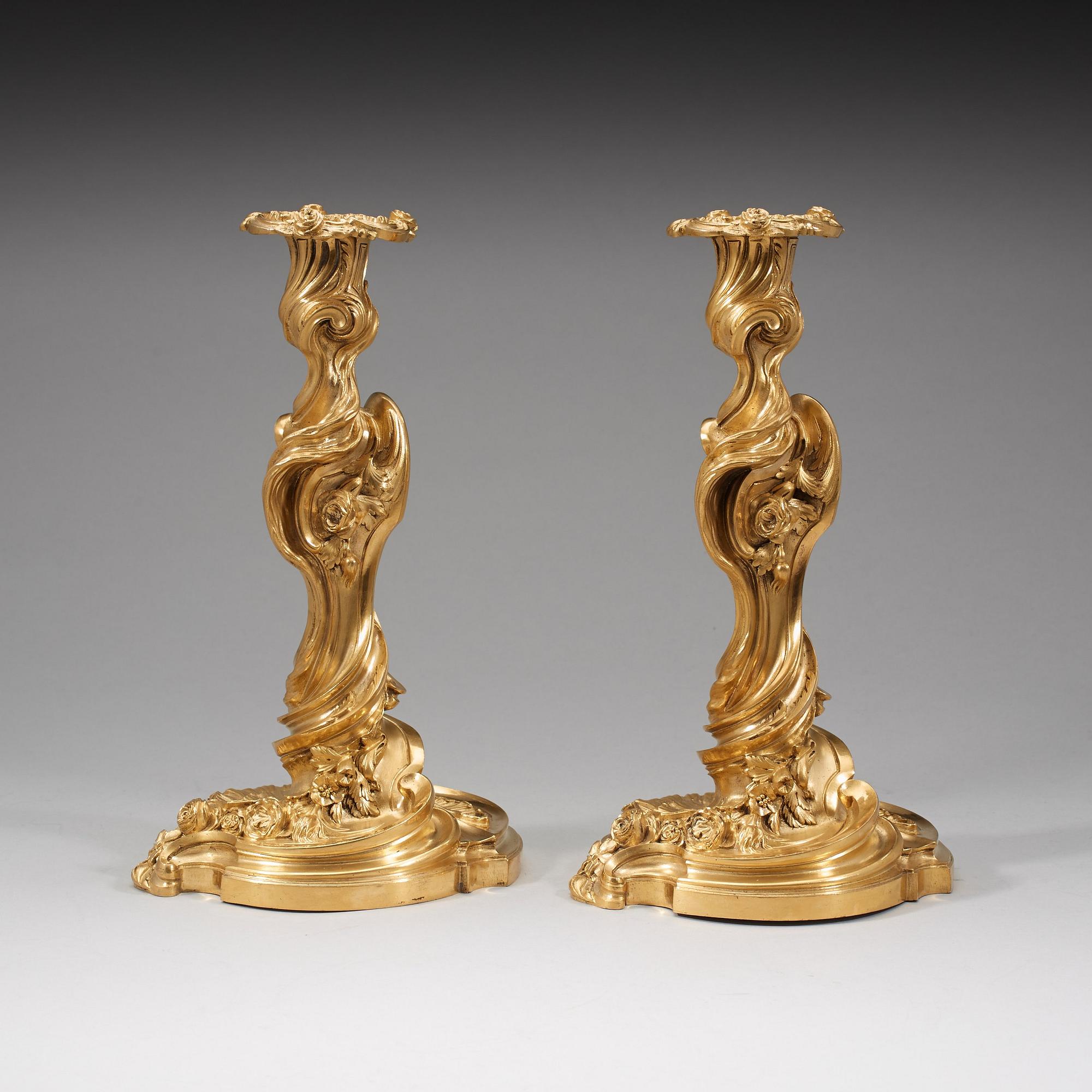 A pair of Louis XV 18th century gilt bronze candlesticks after the model by Juste-Aurèle Meissonnier.