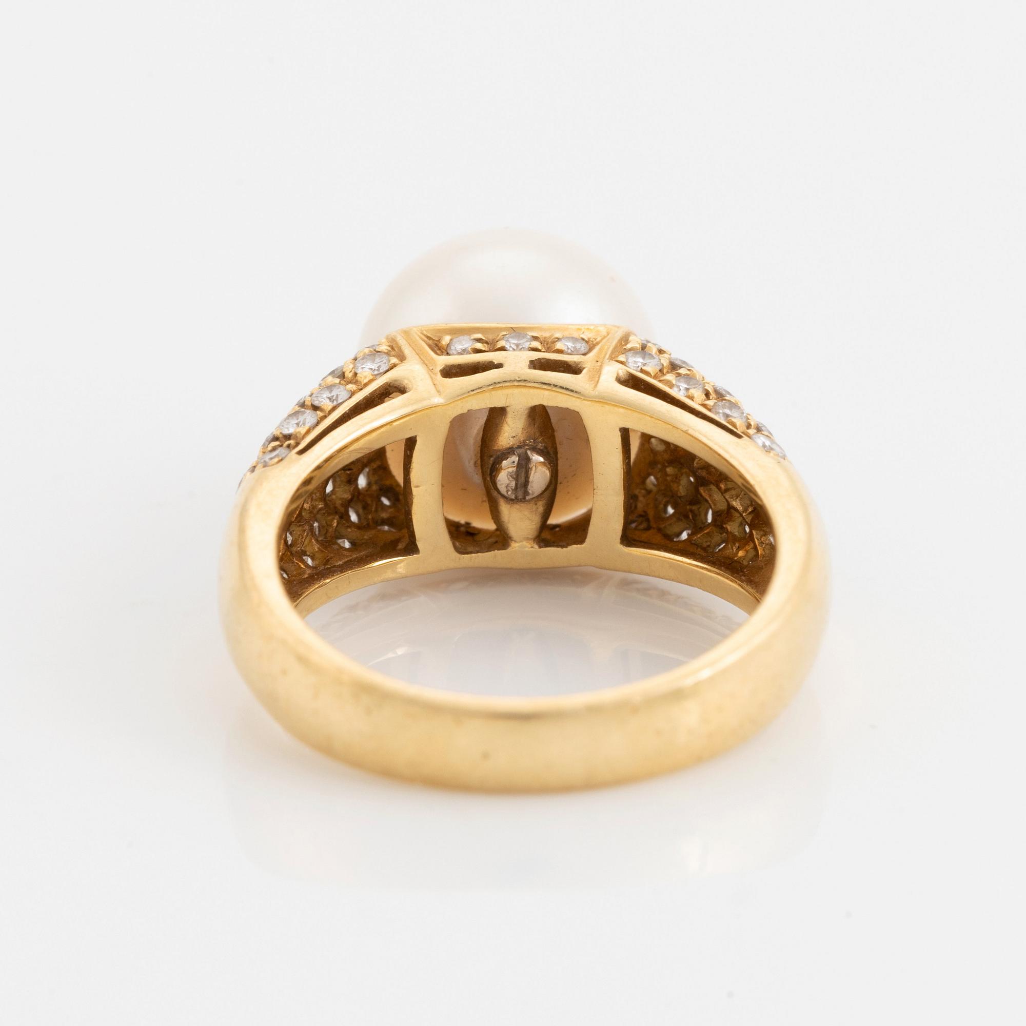 An 18K gold ring set with a cultured South Sea pearl and round brilliant-cut diamonds.