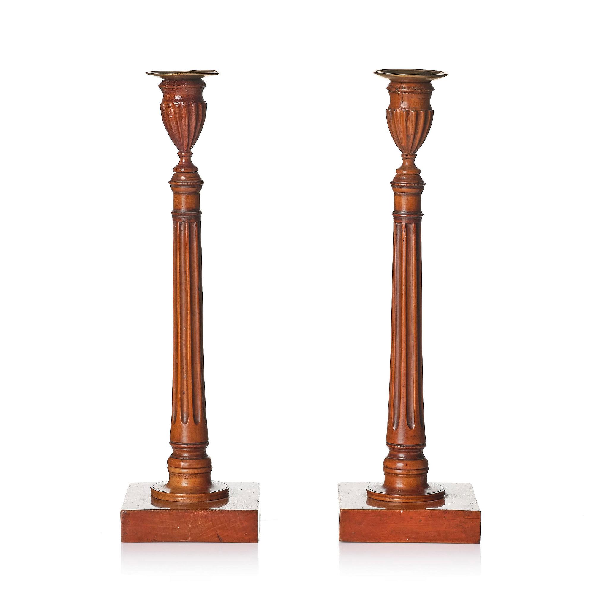A pair of George III mahogany candlesticks, circa 1800.