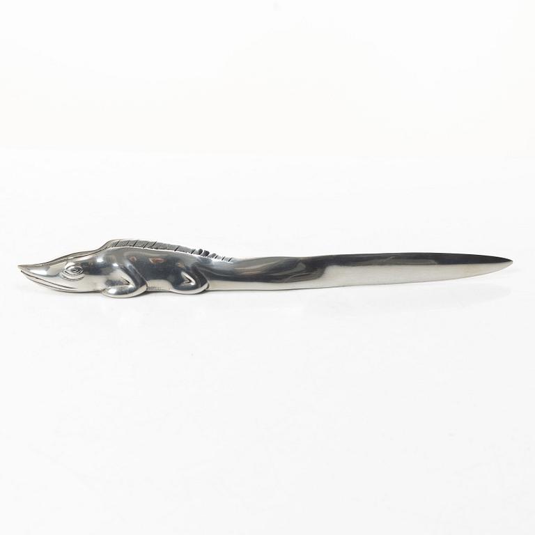 Firma Svenskt Tenn, Candelabrum, 'Vänskapsknuten', and paper knife, 'Alligator'.
