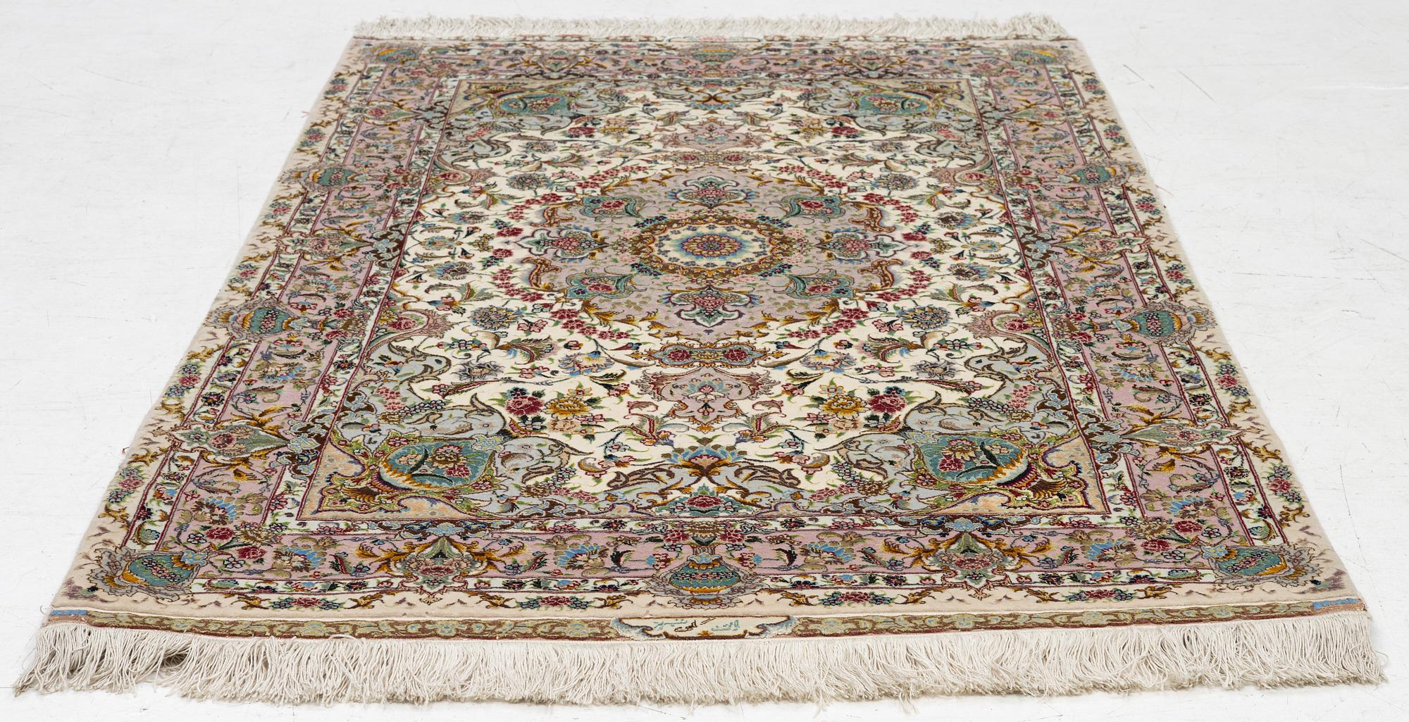 A Tabriz rug, signed, c. 160 x 101 cm.