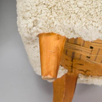 A pair of mid-20th century armchairs in sheepskin.