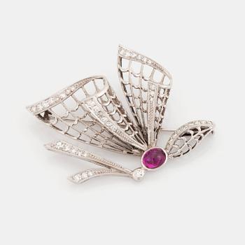 456. An 18K white gold brooch set with a cabochon-cut ruby and eight-cut diamonds.