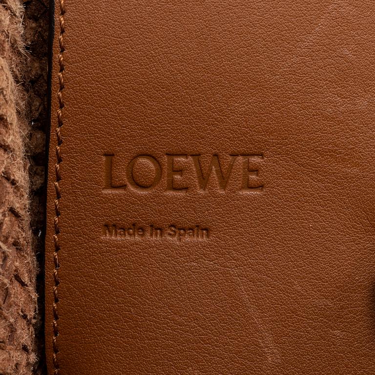 Loewe, a brown woven leather handbag.