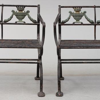 GARDEN SOFAS, a pair, cast iron, empire style, late 19th century.