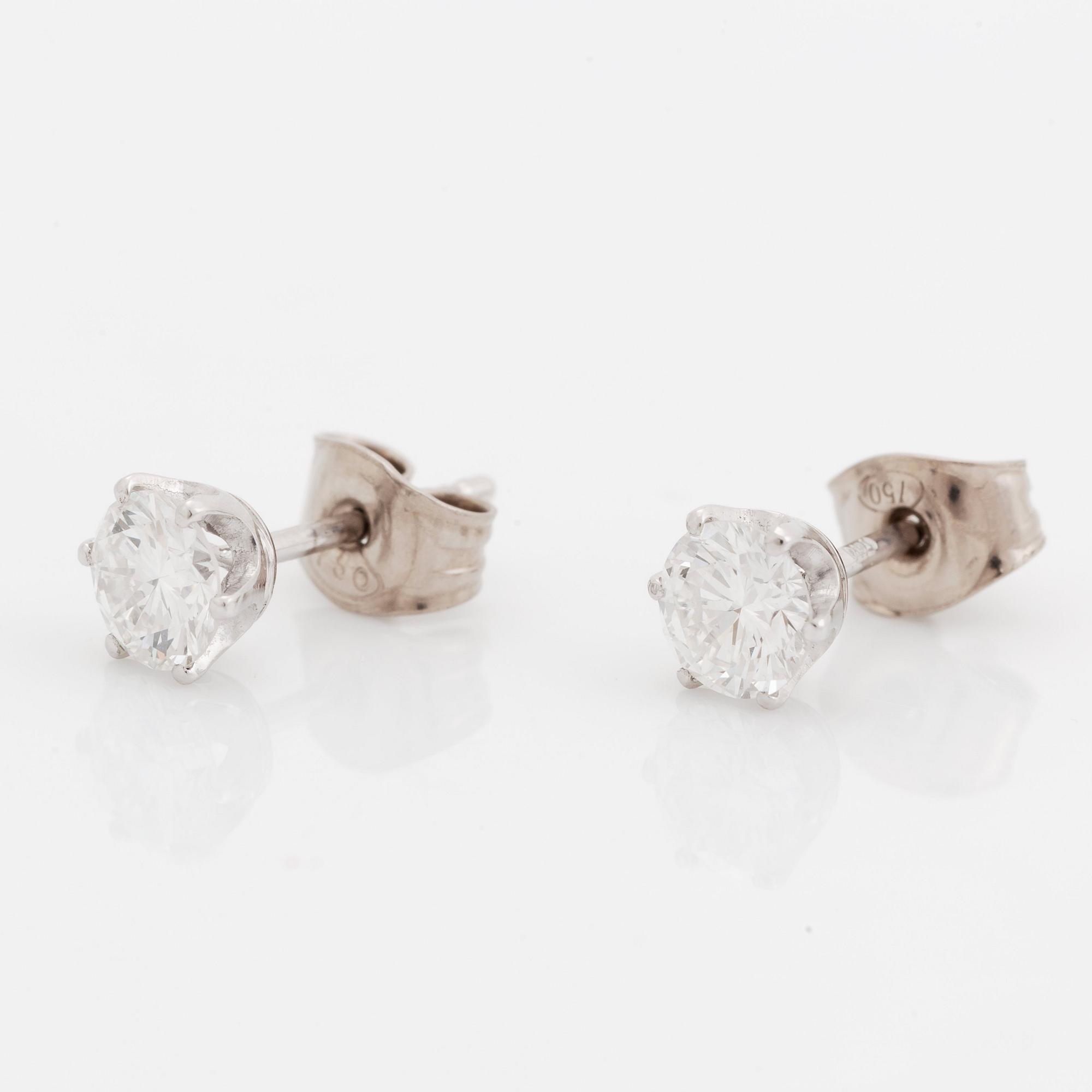 A pair of 18K white gold earrings set with two round brilliant-cut diamonds.