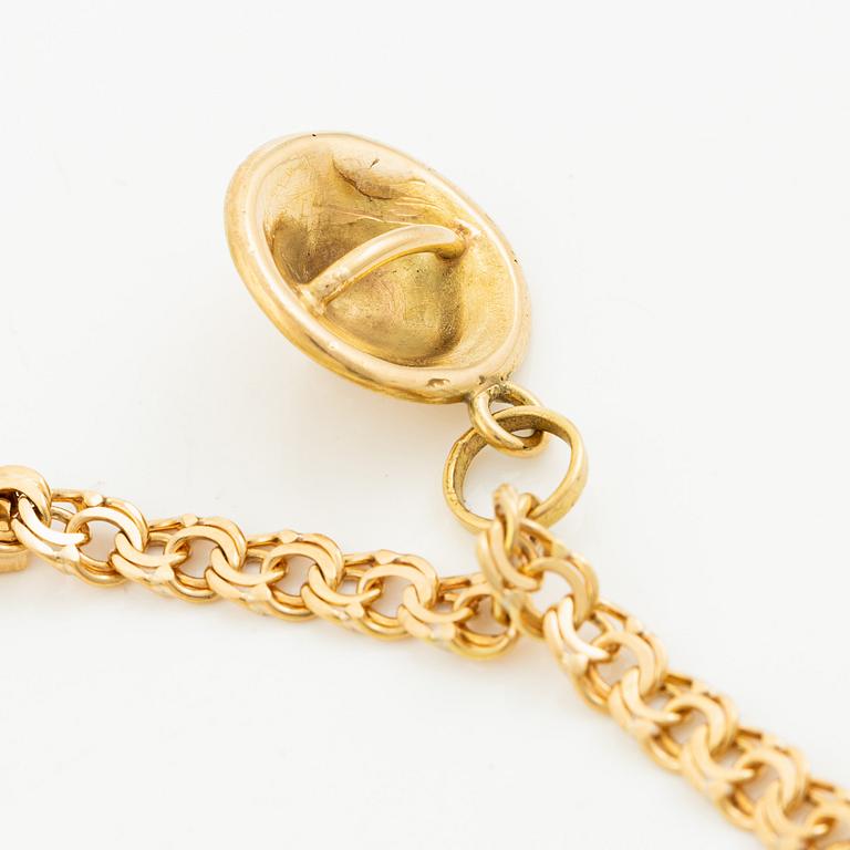 Bracelet, 18K gold bismarck link. With charms.