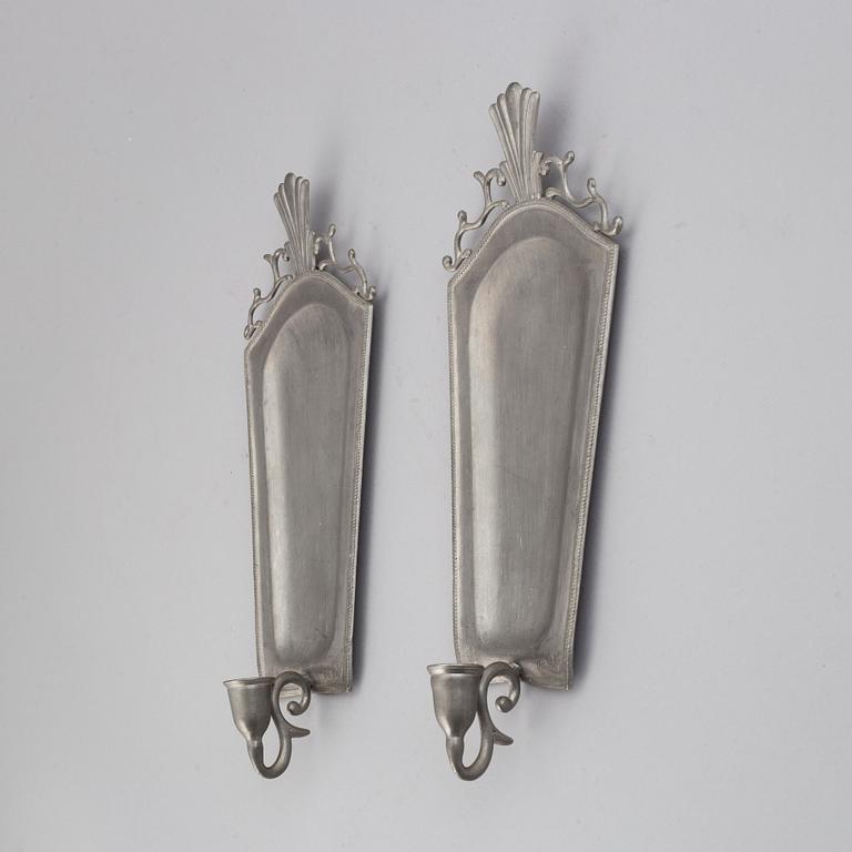 A pair of 20th century pewter wall sconces for ine candle.