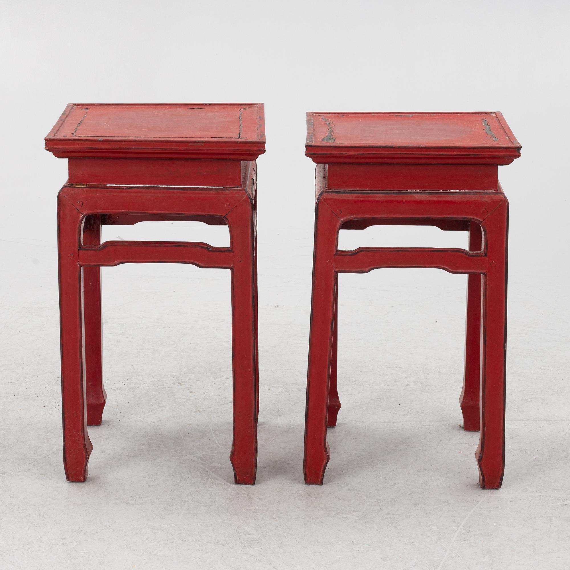 A pair of red Chinese small tables, 20th century.