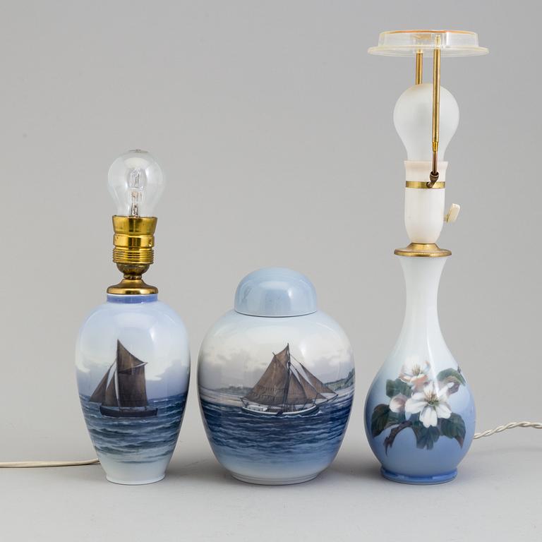 Two mid 20th century Royal Copenhagen porcelain table lights and a jar with lid.