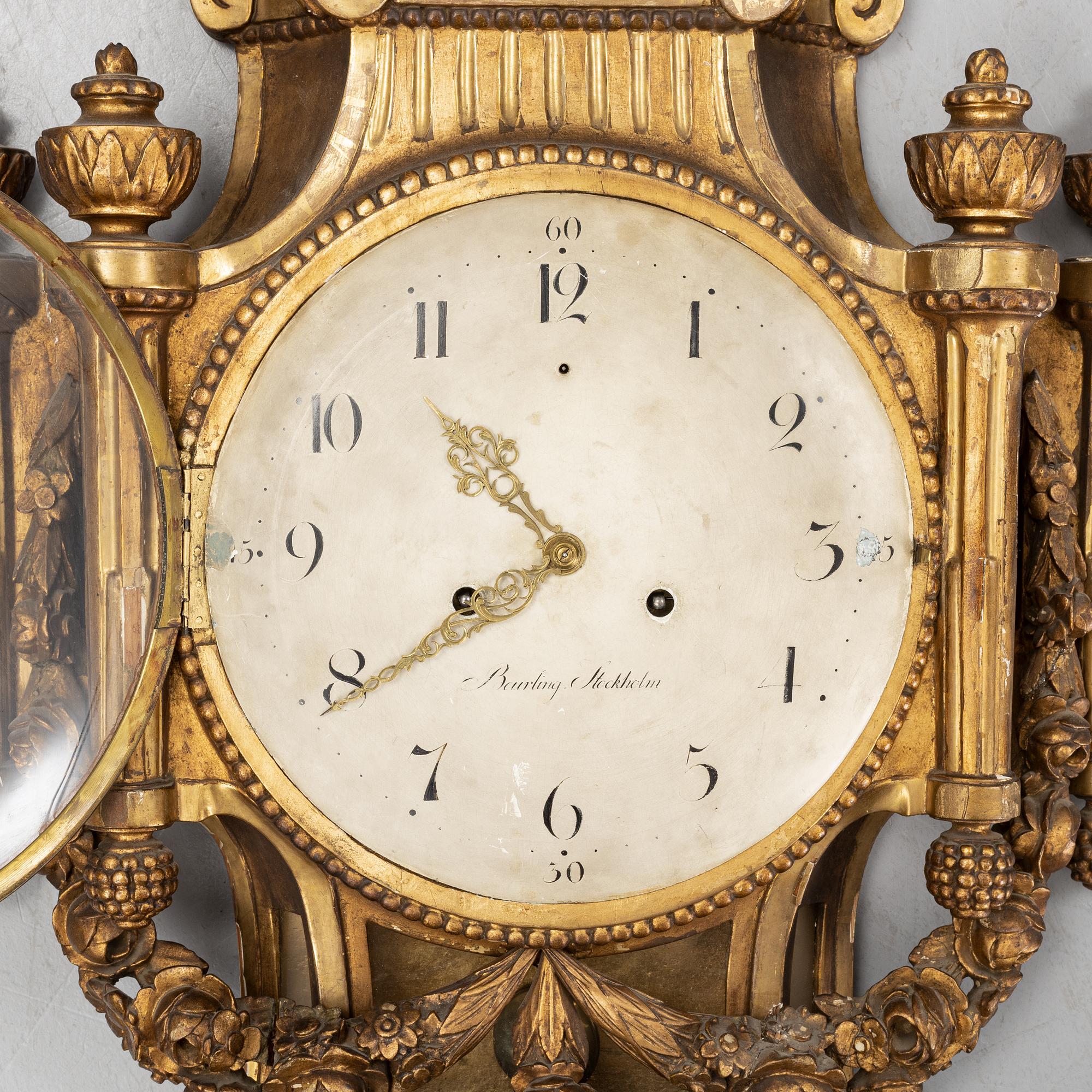 A Gustavian giltwood and parcel-gitl cartel clock by Per Henrik Beurling (Stockholm 1783-1806).