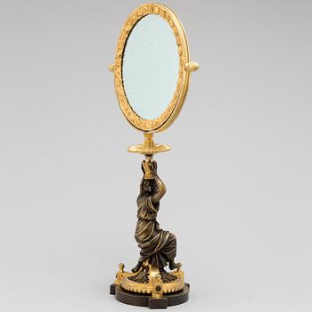 AN EMPIRE ORMOLU TABLE MIRROR, first half of the 19th century.