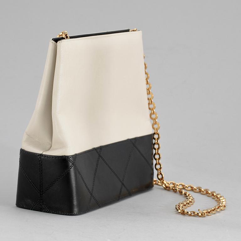 A black and white leather shoulder bag by Salvatore Ferragamo.