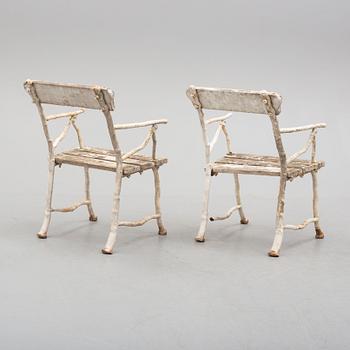 a pair of early 20th century garden cast iron chairs.