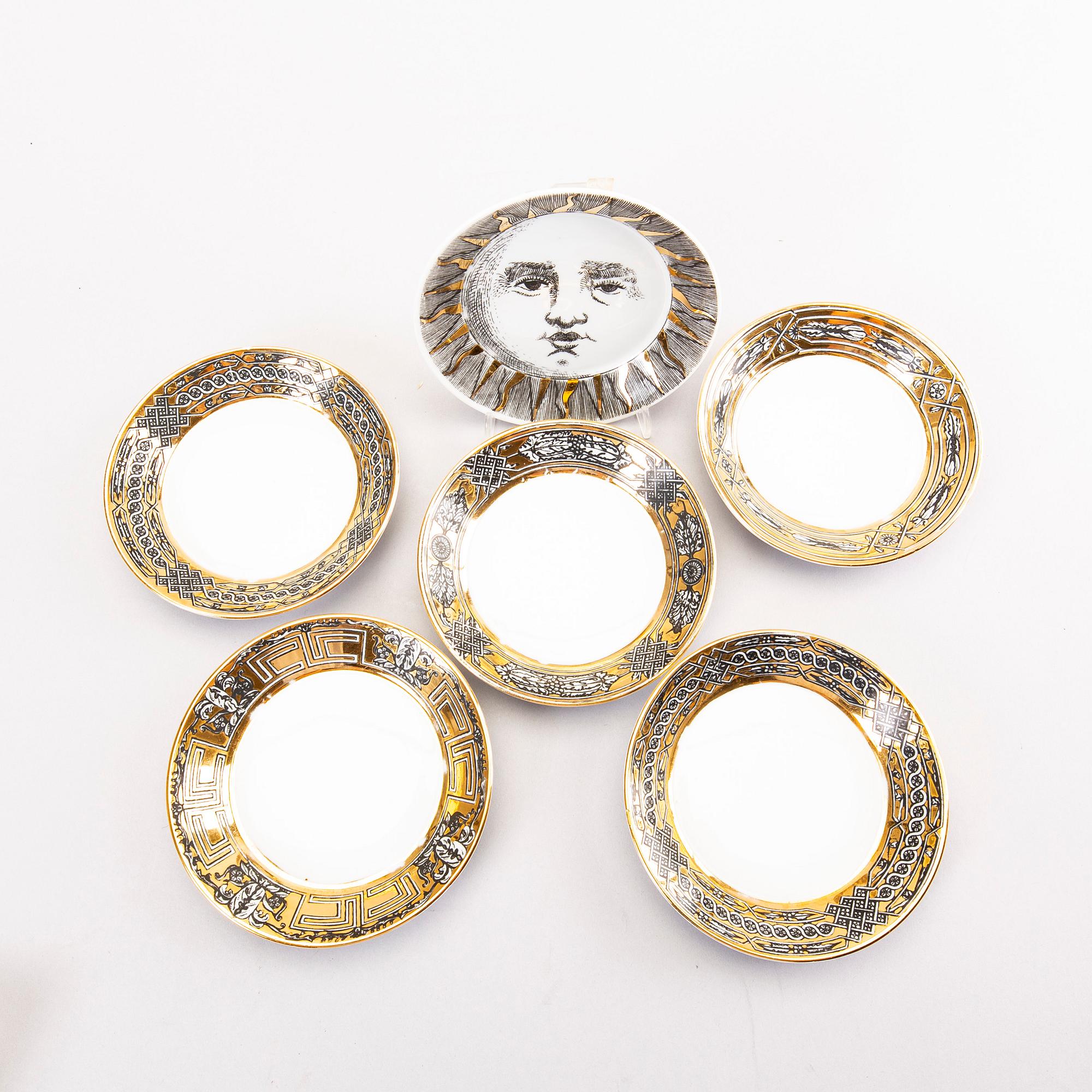 Piero Fornasetti a set of four coffee cups with saucers and two ashtrays.
