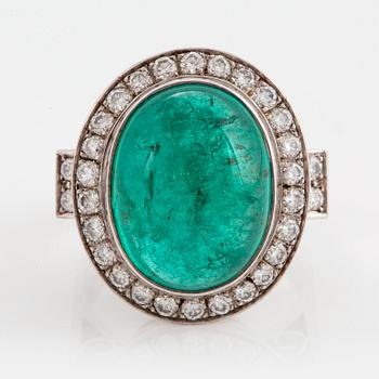 1031. An 18K white gold ring set with a cabochon-cut emerald and round brilliant-cut diamonds.