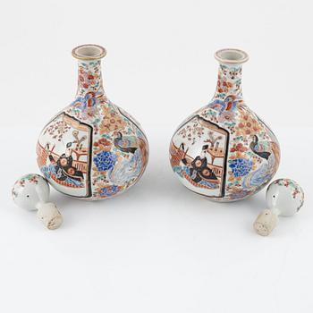 A set of Japanese porcelain bottles with stoppers, early 20th century.