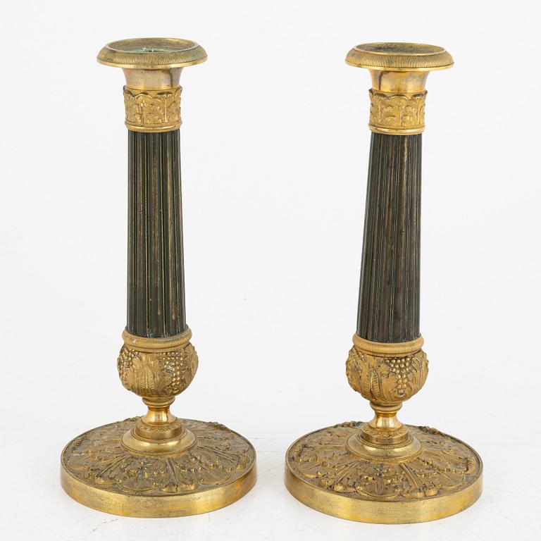 A pair of French Empire ormolu and patinated bronze candlesticks, first part of the 19th century.