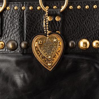 Gucci, a black leather handbag.