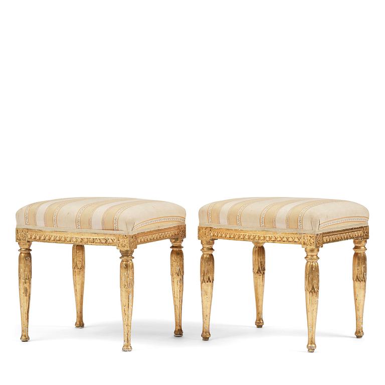 A near pair of late Gustavian giltwood stools, one by J. Hammarström (master in Stockholm 1794-1812).