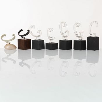 Clock stands, 7 pcs, Breitling, TAG Heuer and Girard-Perregaux.