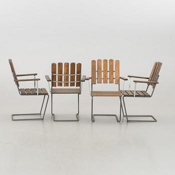 A GARDEN TABLE AND FOUR ARMCHAIRS FORM GRYTHYTTAN.