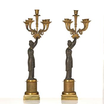 A pair of Fernch Empire ormolu and patinated bronze five-light candelabra, early 19th century.