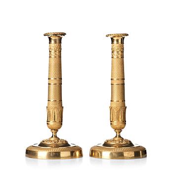 132. A pair of French Empire early 19th century candlesticks.