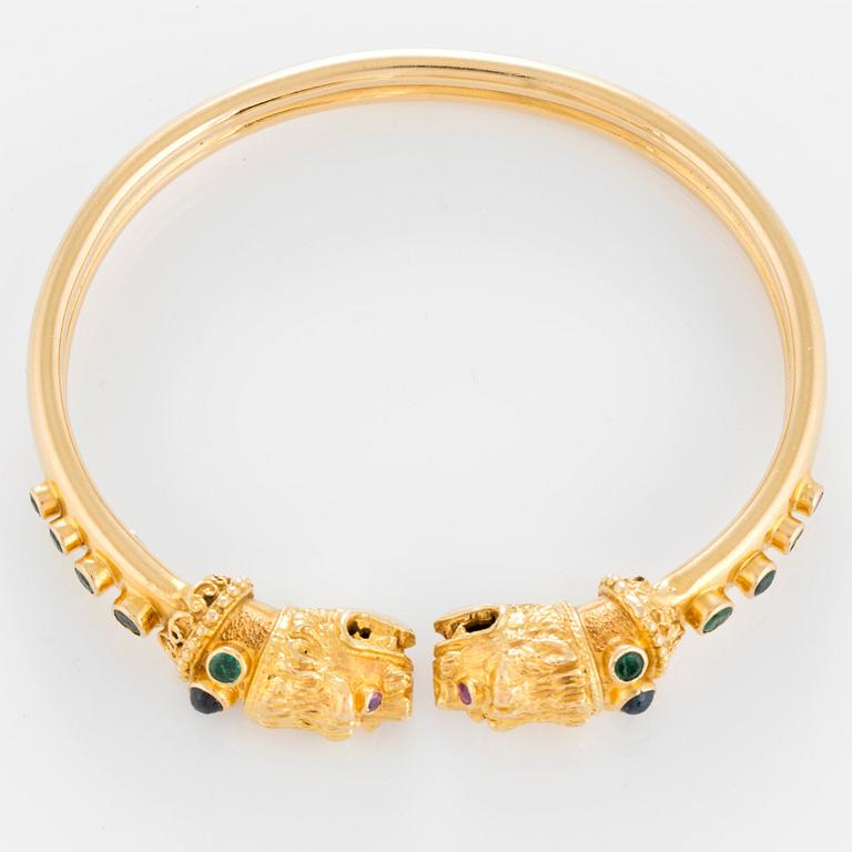 An Ilias Lalaounis bracelet in 18K gold set with emeralds, sapphires and rubies.