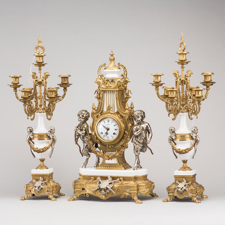 A LOUIS XVI STYLE GILT-BRASS CLOCK GRANITURE. Italy, SECOND HALF OF 20TH CENTURY.