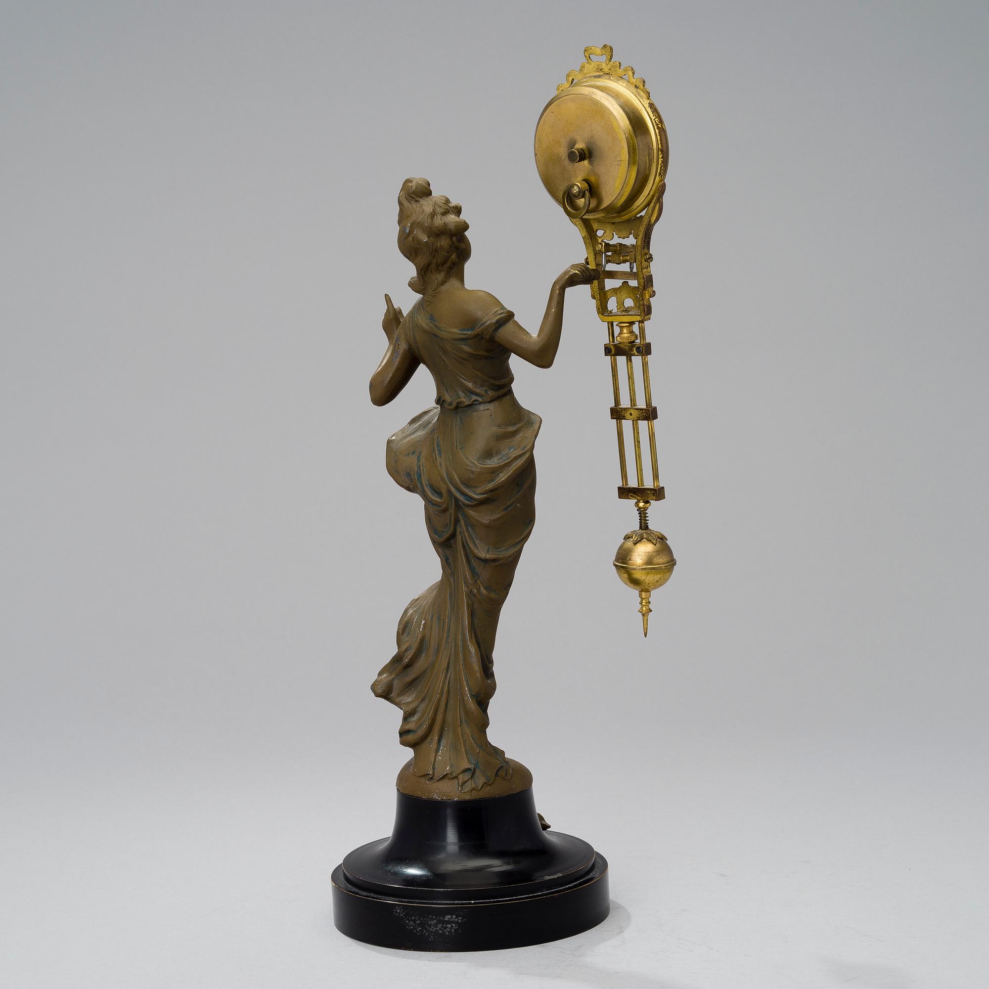 A 1930s Junghans swinger clock with girl sculpture.