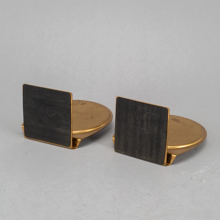 A pair of brass book ends, mid 20th century.