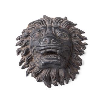 118. Anna Petrus, a cast iron mascaron in the shape of a lion's head.