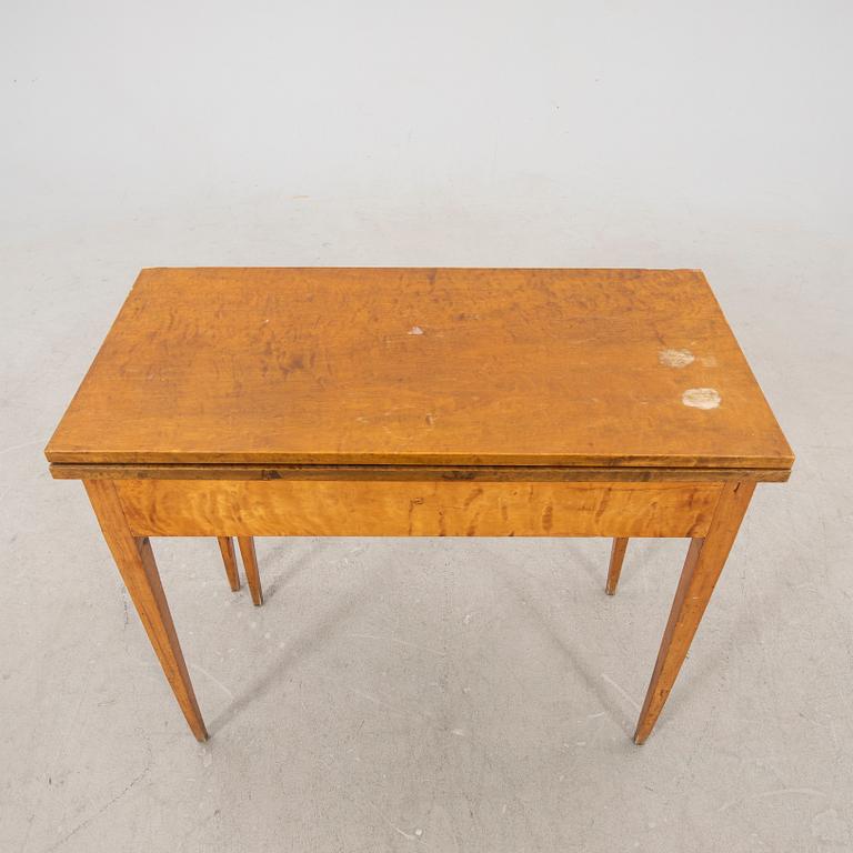 An earluy 1900s birch game table.