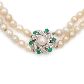 A double strand cultured pearl necklace Clasp set with diamonds and emeralds.