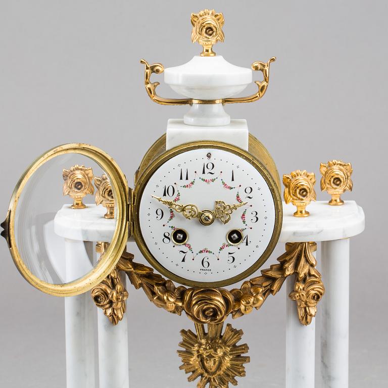 A Louis XVI-style mantle clock.